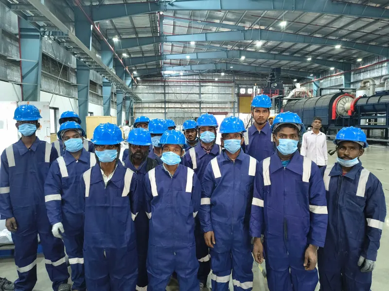 Team in helmets and masks on the plant floor