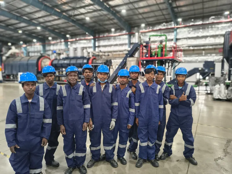 Saava Greens team in uniform in front of the processing line